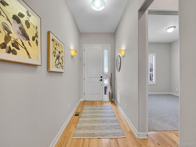 doorway to outside with wood-type flooring