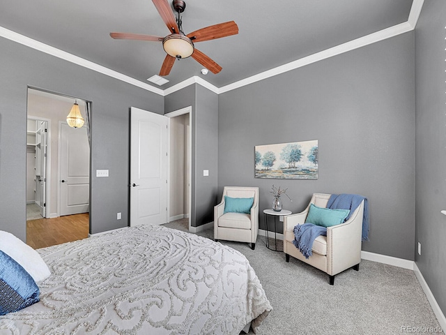 bedroom featuring crown molding, carpet floors, and ceiling fan