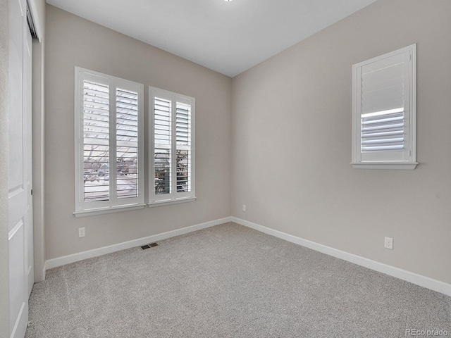 unfurnished room with light carpet