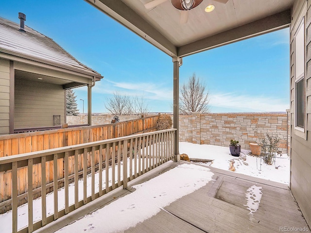 snow covered patio featuring ceiling fan