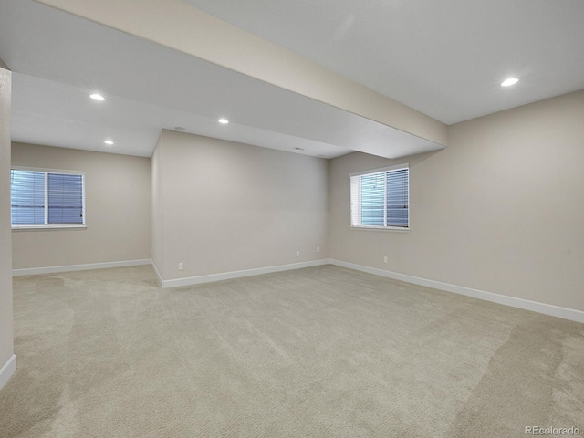 basement featuring light colored carpet