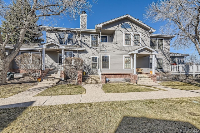 view of front of house with a front lawn and a chimney