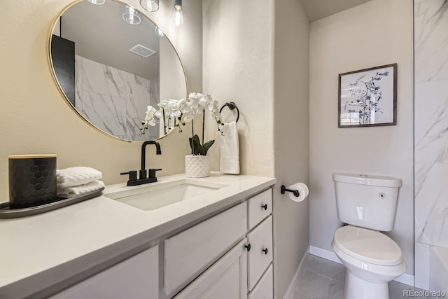 bathroom with baseboards, visible vents, vanity, and toilet