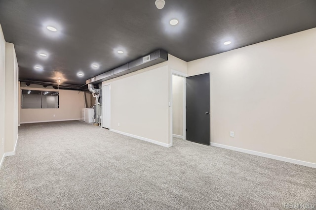 below grade area with carpet floors, visible vents, baseboards, and recessed lighting