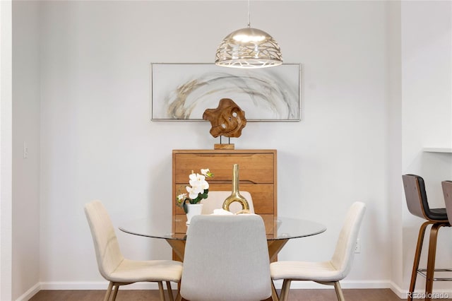 dining area with wood finished floors and baseboards