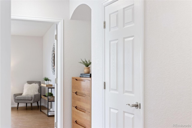 hall with wood finished floors and baseboards