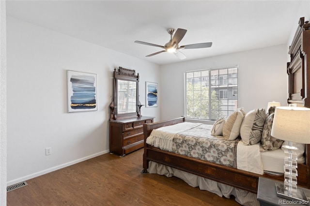 bedroom featuring wood finished floors, visible vents, baseboards, and ceiling fan