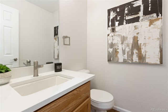 bathroom with toilet and vanity