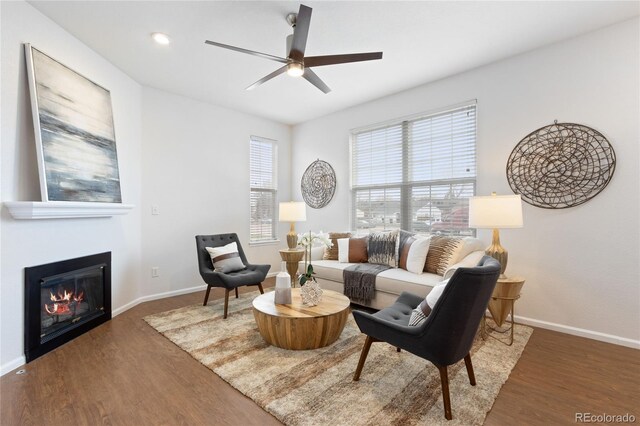8251 W 54th Ave Unit 4, Arvada, CO 80002 - living area featuring wood finished floors, ceiling fan, and a glass covered fireplace