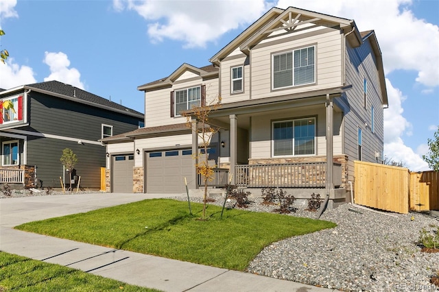 craftsman inspired home featuring a porch, a garage, and a front lawn