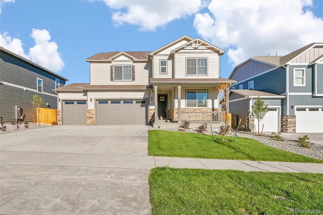 craftsman-style home with a garage, covered porch, and a front yard