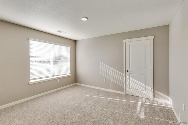 unfurnished room with carpet floors