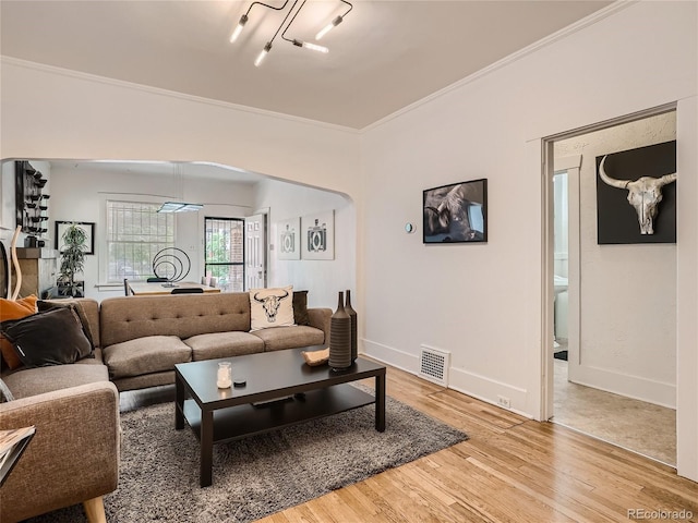 living room with crown molding and hardwood / wood-style flooring