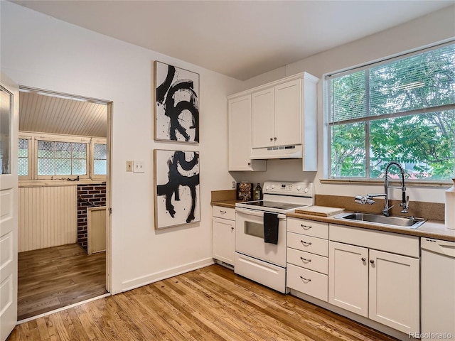 kitchen featuring sink, white appliances, light hardwood / wood-style flooring, and white cabinets