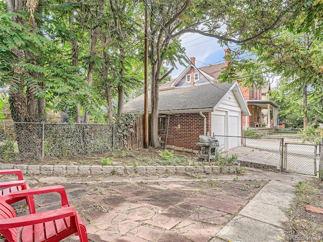 view of front of house featuring a garage and a patio area