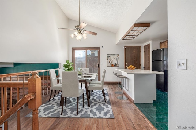 18083 E Atlantic Dr, Aurora, CO 80013 - dining space featuring ceiling fan, lofted ceiling, wood finished floors, and a textured ceiling