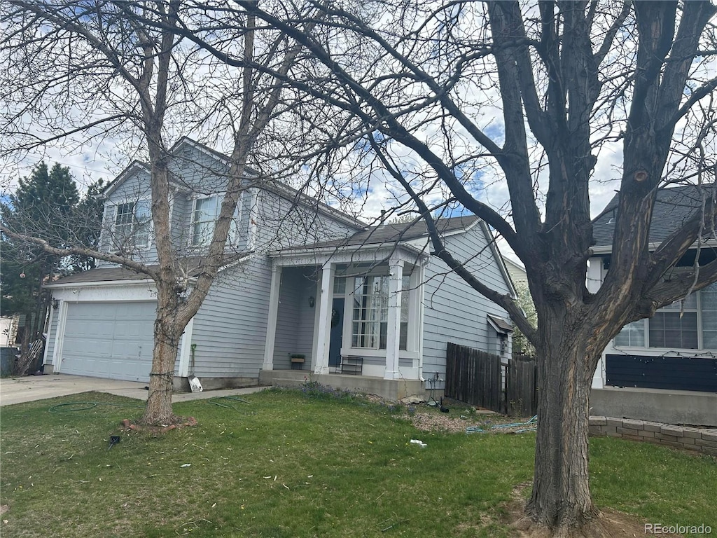 view of front of house featuring a garage, covered porch, and a front yard