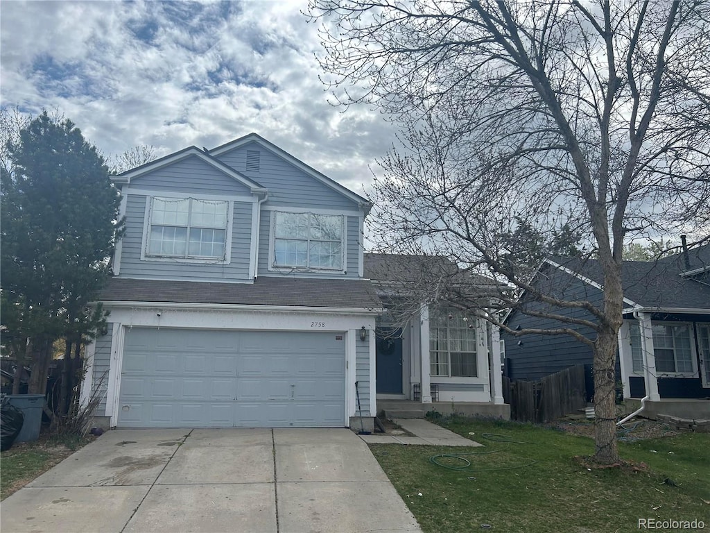 view of front property featuring a front yard and a garage