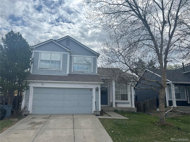 view of front property featuring a front yard and a garage