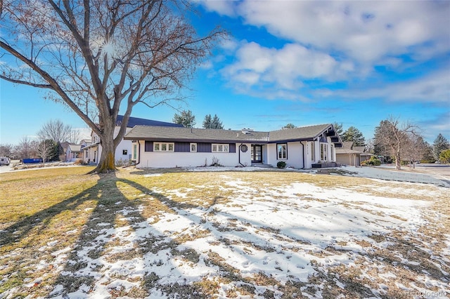 ranch-style home with a lawn