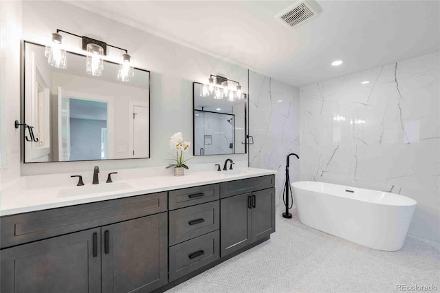 bathroom with separate shower and tub, vanity, and tile patterned floors