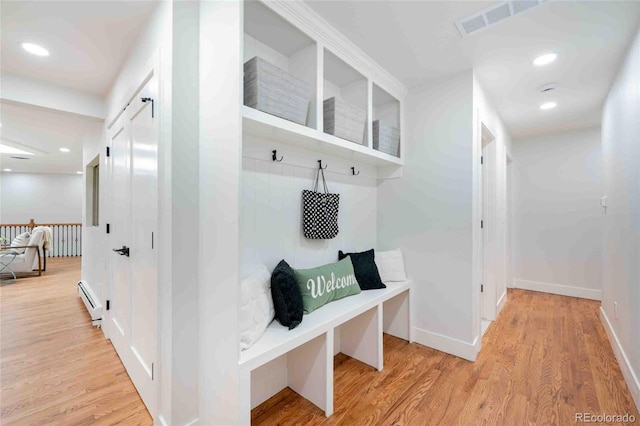 mudroom with baseboard heating and light hardwood / wood-style flooring