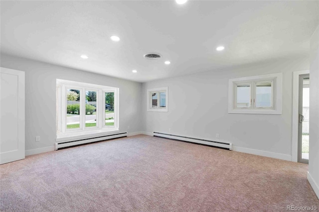 unfurnished room featuring light colored carpet and a baseboard heating unit