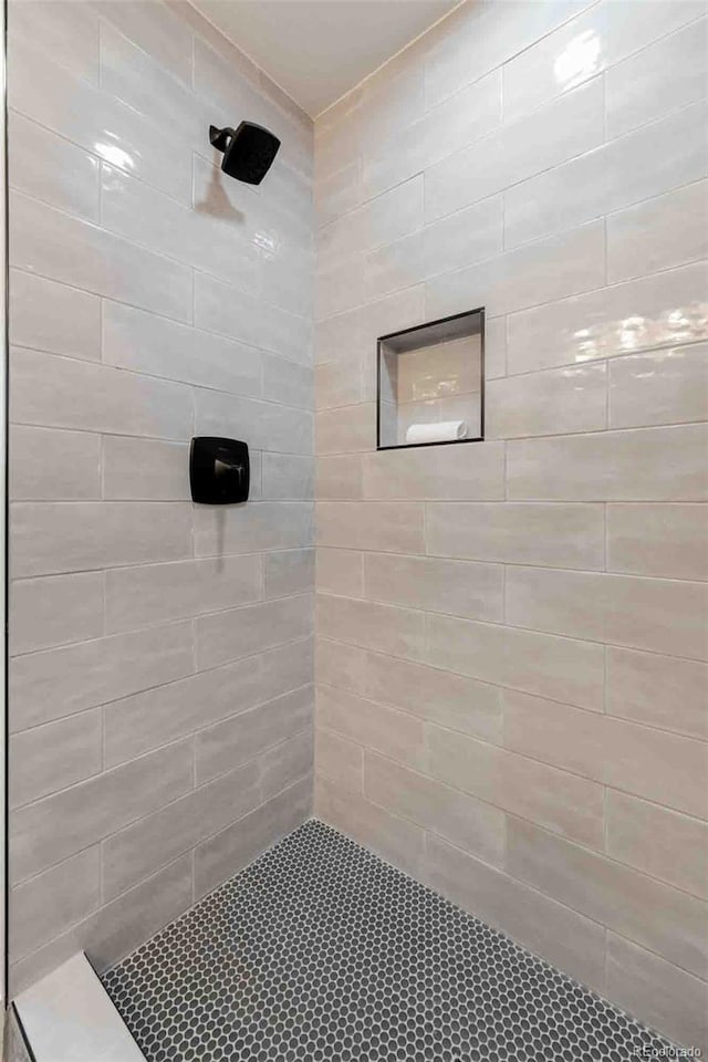 bathroom with a tile shower