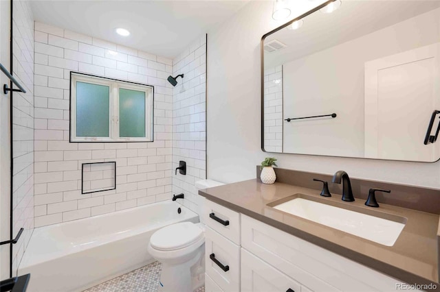 full bathroom featuring toilet, vanity, tile patterned flooring, and tiled shower / bath