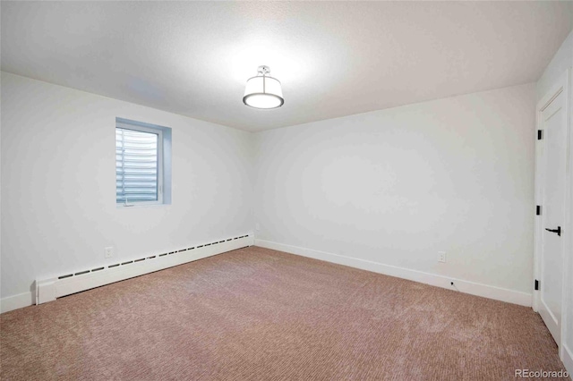 spare room with a baseboard radiator and carpet