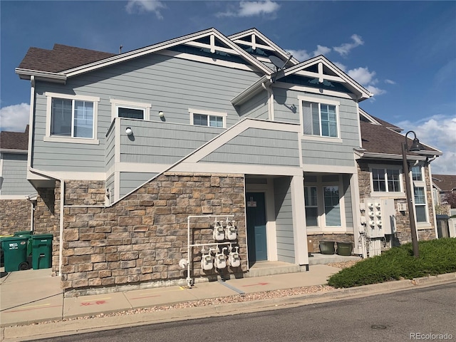 craftsman-style home with stone siding