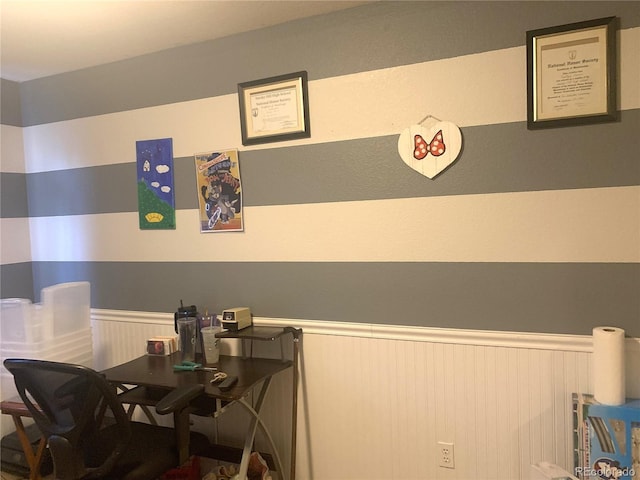 dining area featuring wainscoting
