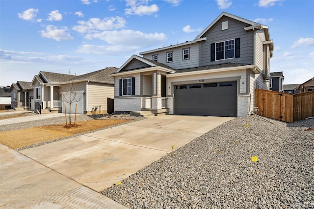 view of front of house featuring brick siding, an attached garage, concrete driveway, and fence