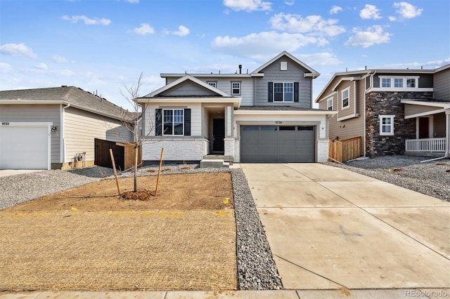 view of front of home with a garage, concrete driveway, and fence