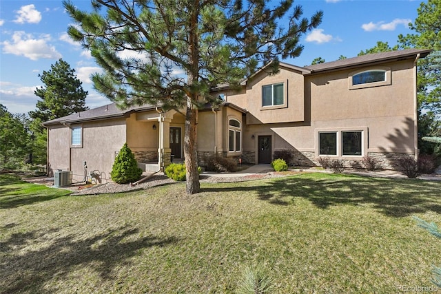17912 Loverly Way, Monument, CO 80132 - rear view of house featuring central air condition unit, stucco siding, a lawn, and stone siding