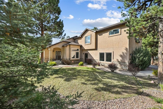 17912 Loverly Way, Monument, CO 80132 - rear view of house featuring a yard, stone siding, and stucco siding