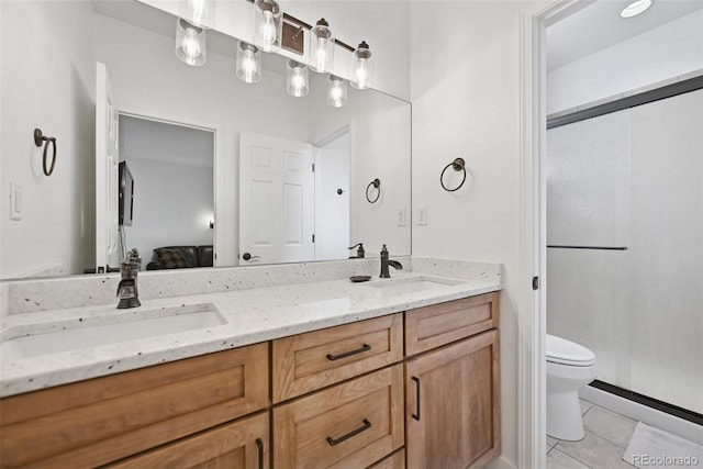 17912 Loverly Way, Monument, CO 80132 - full bath with double vanity, toilet, tile patterned floors, a shower stall, and a sink