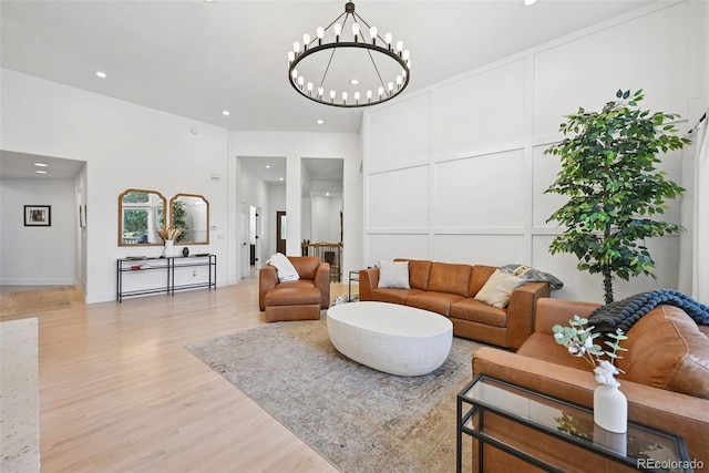 17912 Loverly Way, Monument, CO 80132 - living room with recessed lighting, light wood-style flooring, a decorative wall, and a chandelier