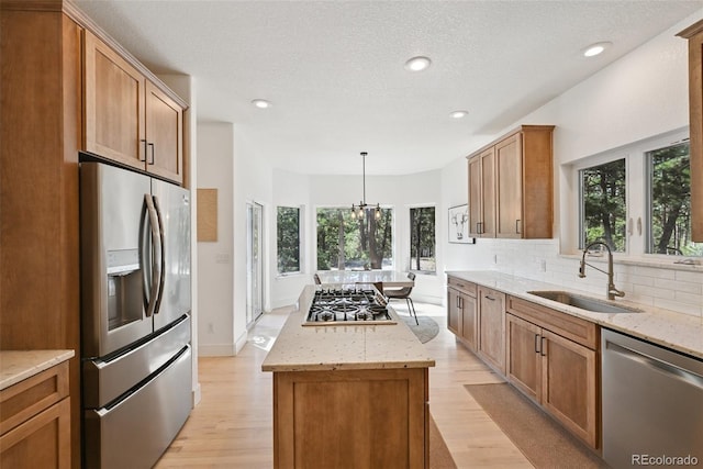17912 Loverly Way, Monument, CO 80132 - kitchen featuring a kitchen island, stainless steel appliances, plenty of natural light, and a sink