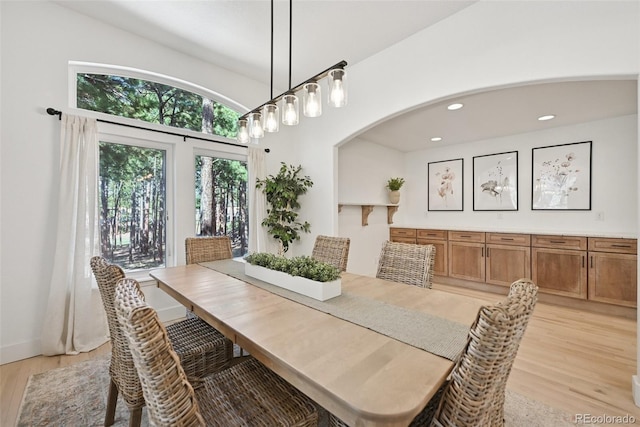 17912 Loverly Way, Monument, CO 80132 - dining room with light wood-type flooring, arched walkways, and recessed lighting
