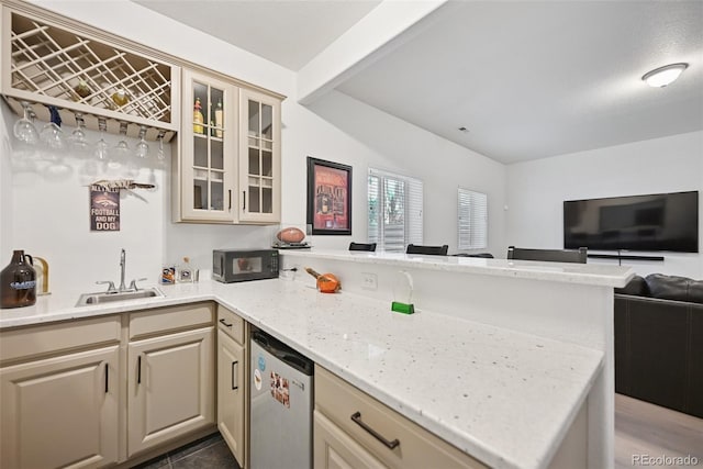 17912 Loverly Way, Monument, CO 80132 - kitchen featuring black microwave, dishwasher, a sink, a peninsula, and open floor plan