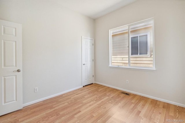 unfurnished room with light hardwood / wood-style flooring