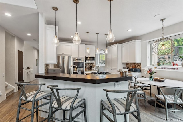6338 Spotted Fawn Run, Littleton, CO 80125 - kitchen featuring stainless steel appliances, dark countertops, white cabinetry, tasteful backsplash, and recessed lighting