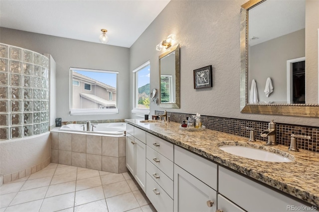 6338 Spotted Fawn Run, Littleton, CO 80125 - full bath featuring double vanity, a garden tub, tile patterned flooring, a textured wall, and tasteful backsplash