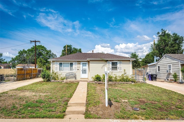 bungalow with fence and a front yard