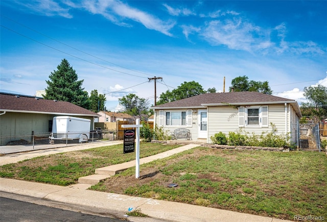 bungalow featuring fence, a gate, and a front lawn