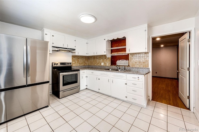 kitchen featuring backsplash, a sink, white cabinets, under cabinet range hood, and stainless steel appliances