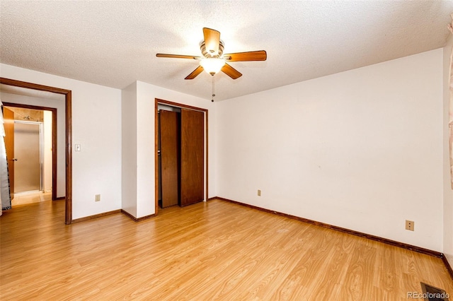 unfurnished bedroom with a closet, baseboards, and light wood-style floors