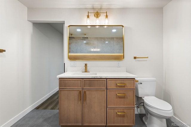 bathroom with wood-type flooring, vanity, and toilet