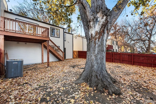 view of yard with a wooden deck and central air condition unit